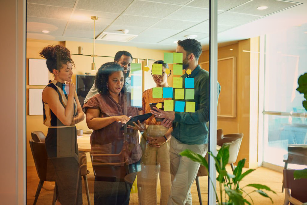 Overhead shot of a diverse team collaborating in a modern office meeting.